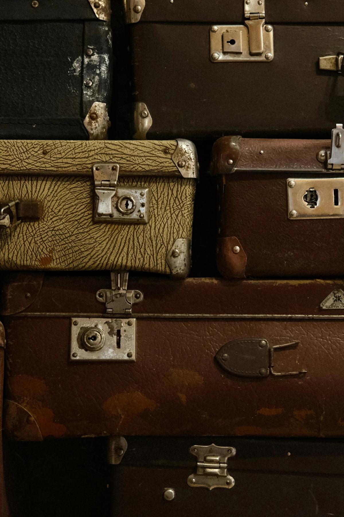 A stack of vintage and old suitcases