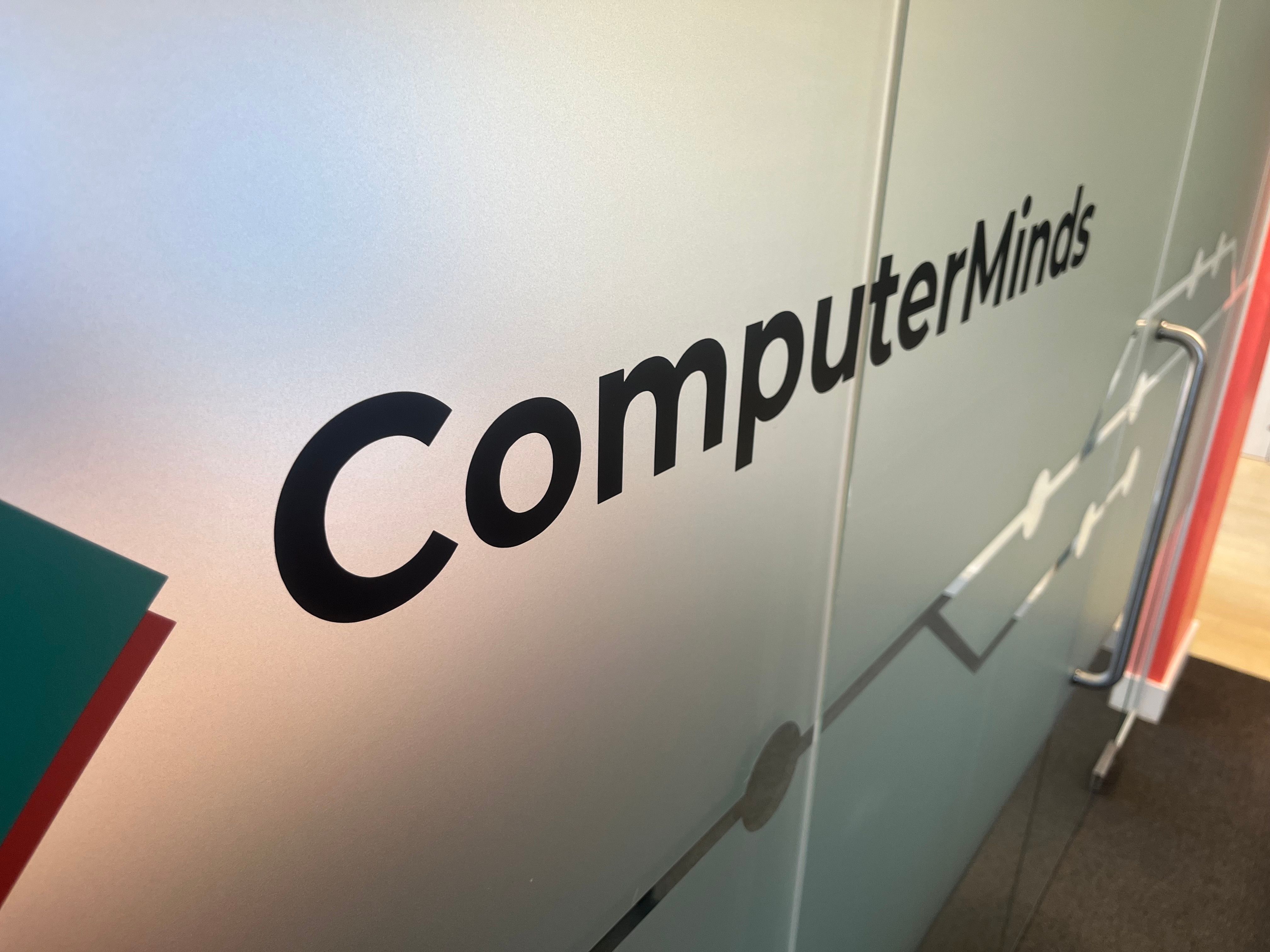 The ComputerMinds logo on the glass wall of our office