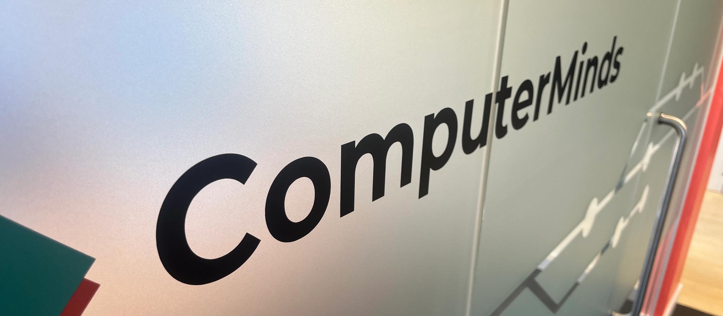 The ComputerMinds logo on the glass wall of our office
