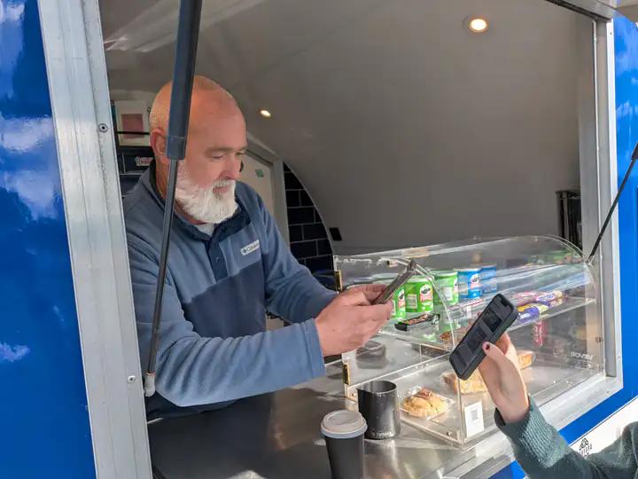 Donal scanning a customer's app at Murf's Coffee Pod