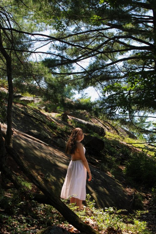 Girl in woods next to mountain