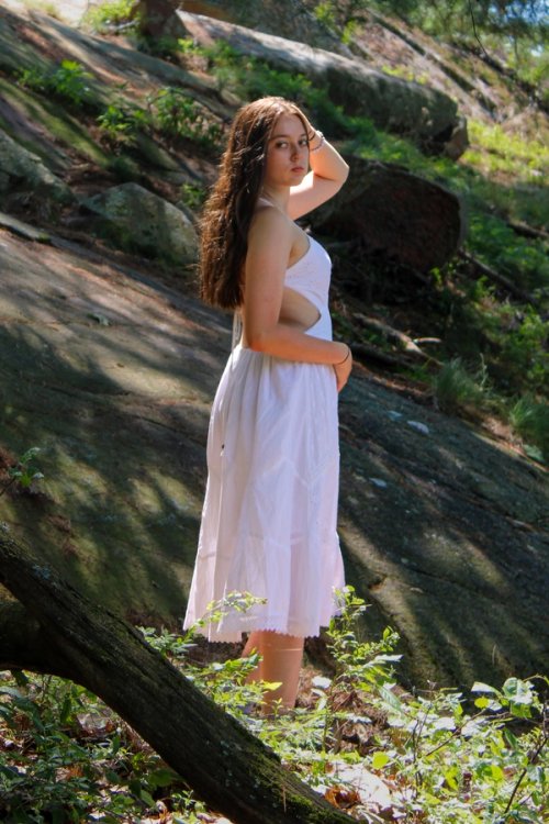 Girl in forest next to mountain