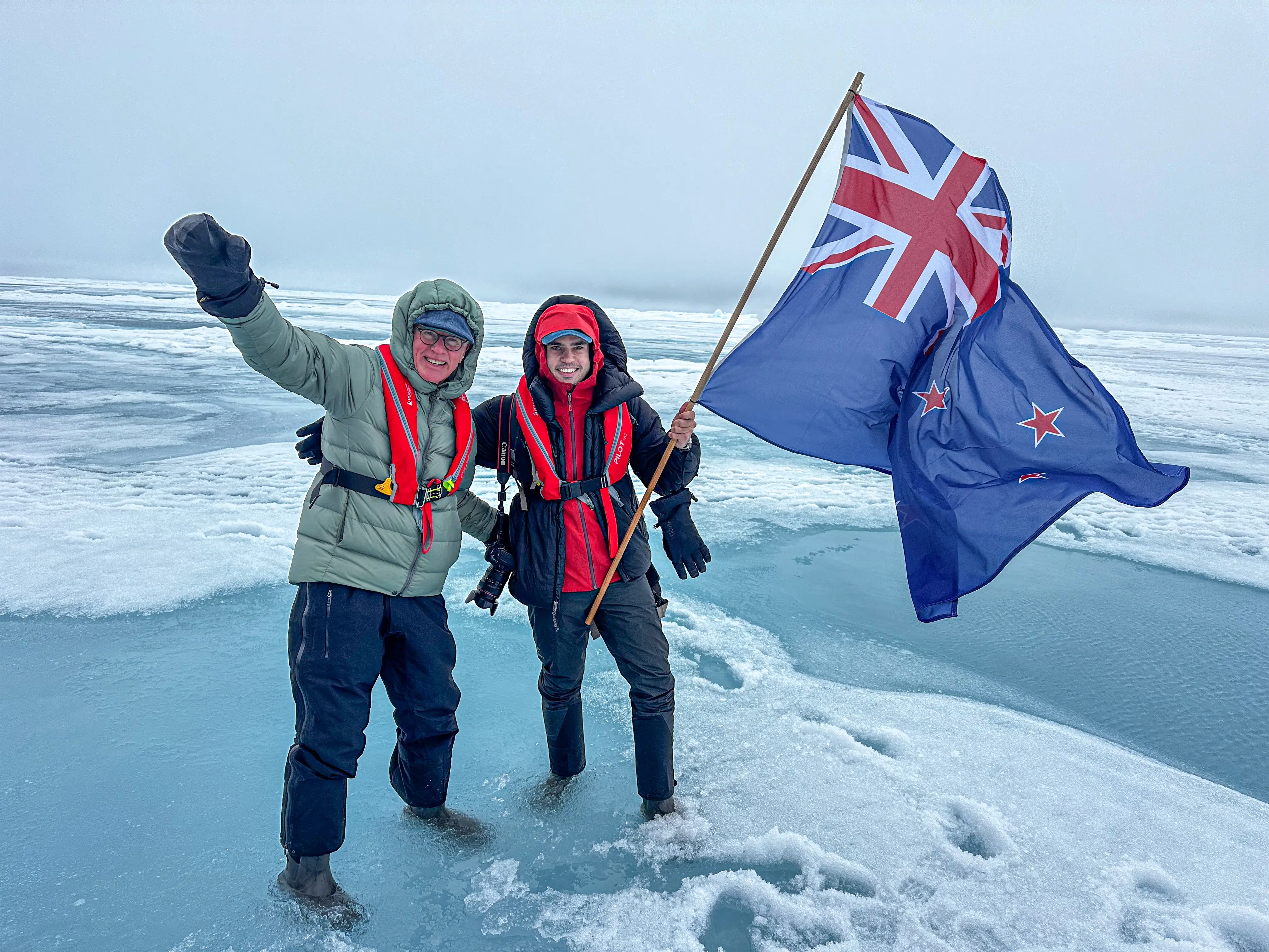 Peter and Alex Hillary holding an NZ flag in the North Pole