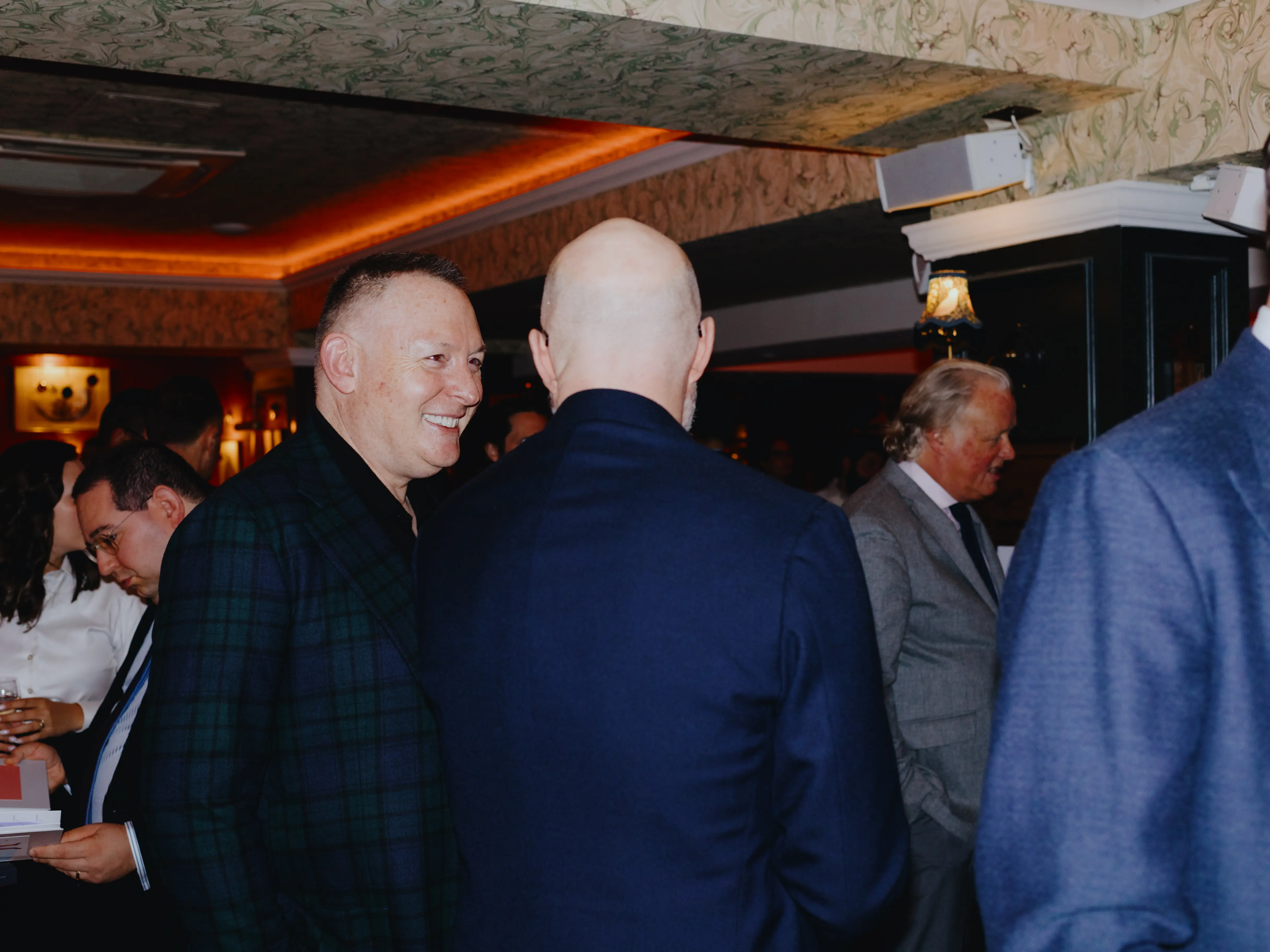 Murray Crane and associate talking in a bar