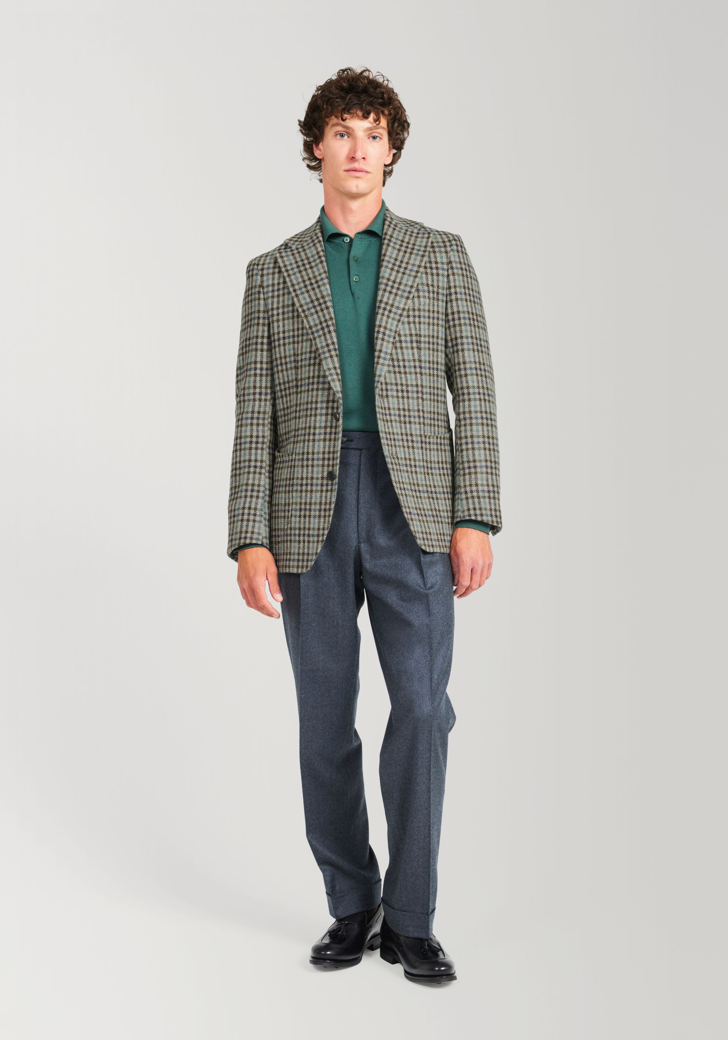 Man in Tweed jacket and grey trousers on light grey background