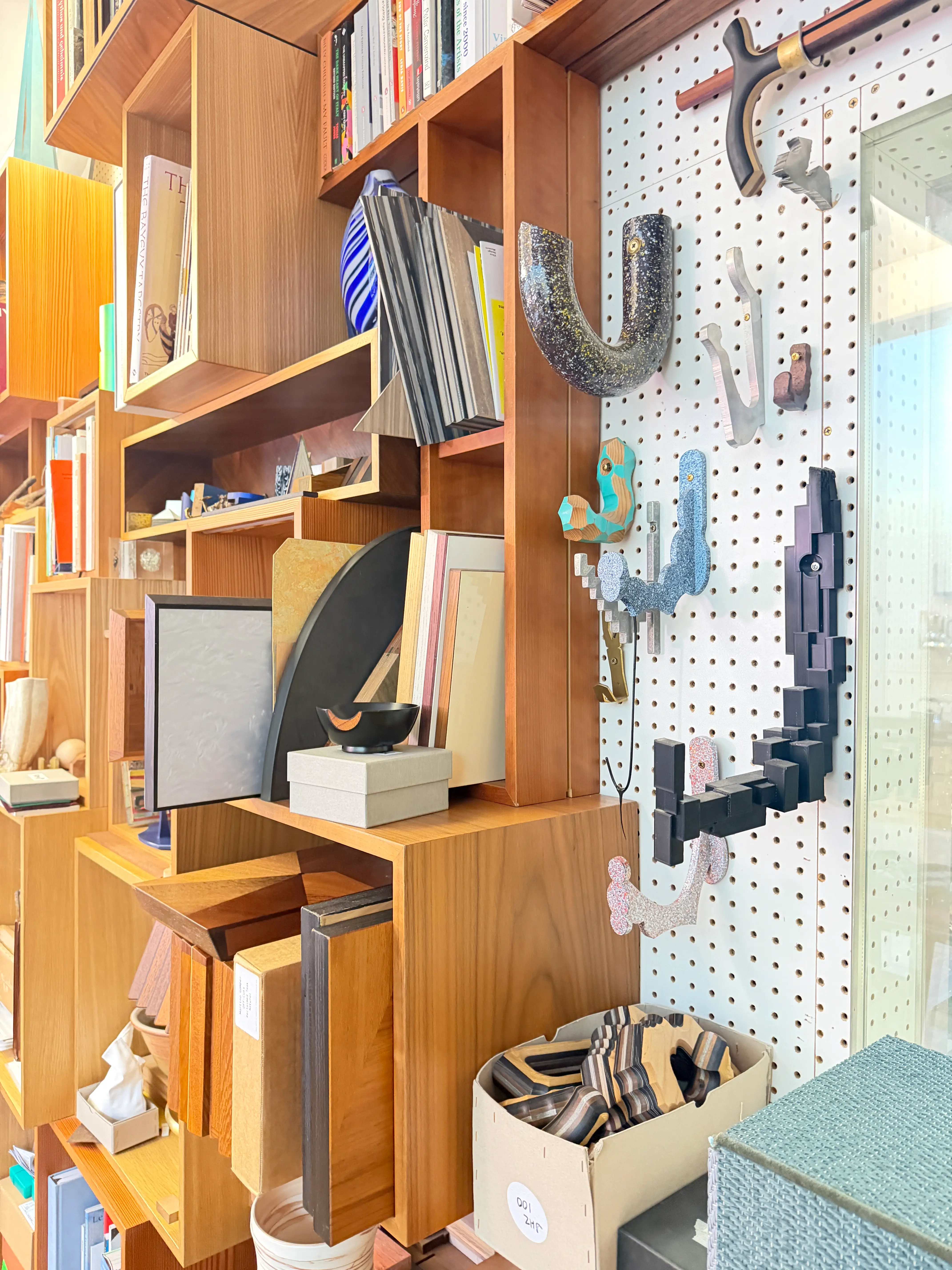 Book case and sculptures on the wall in studio