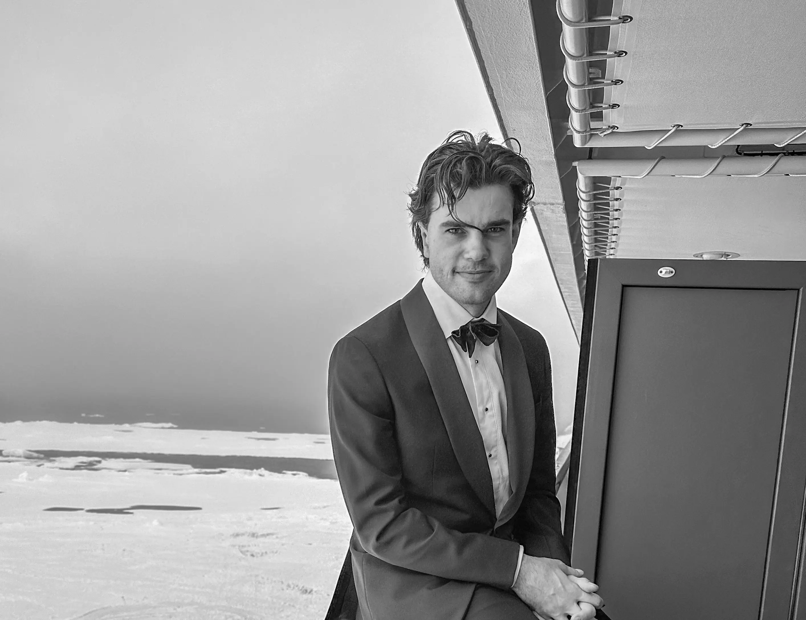 Alex Hillary in a Tuxedo with the Arctic in the background