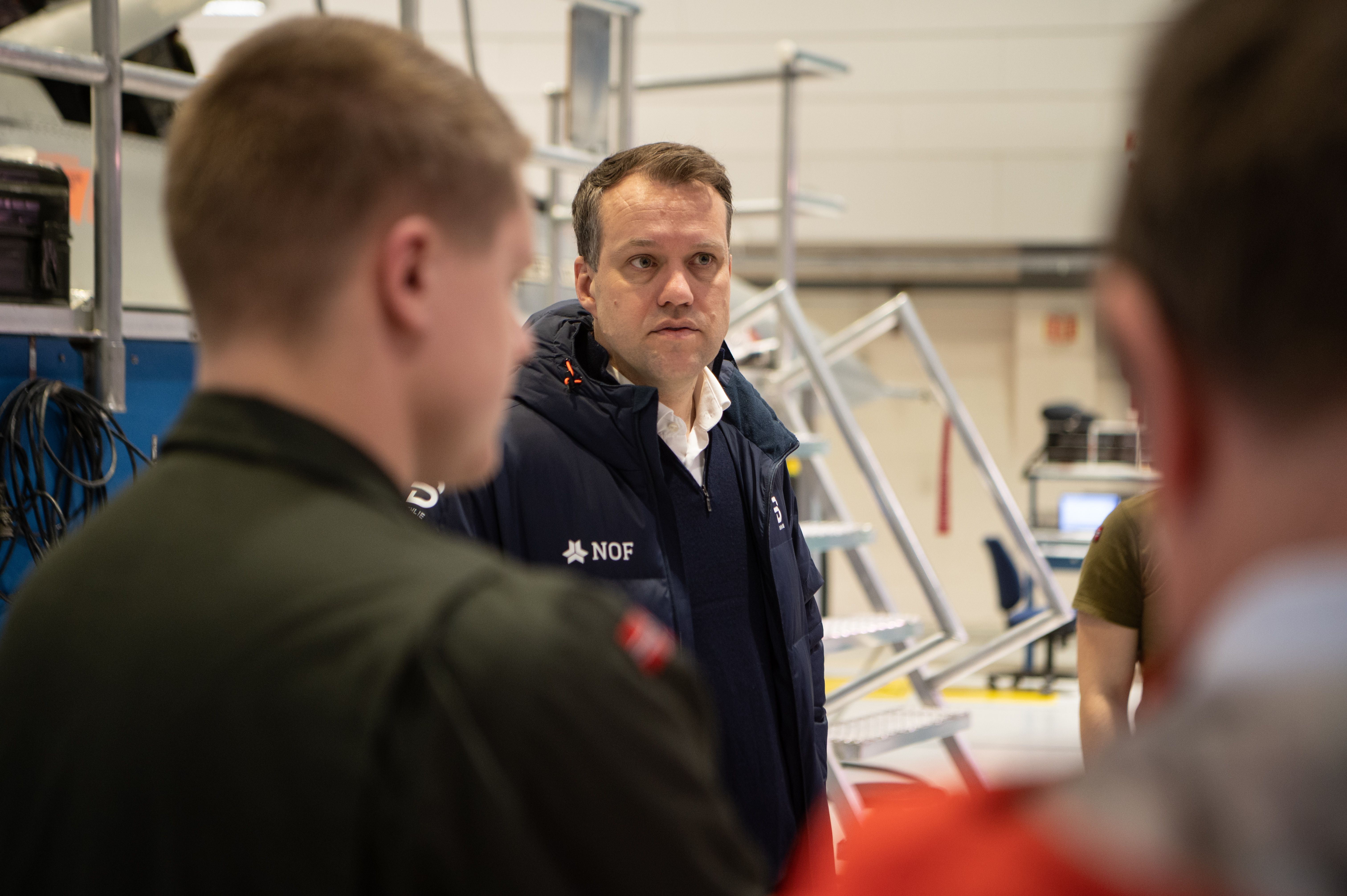 Bilde av Tor Egil Vangstad i samtale med lærlinger på Ørlandet