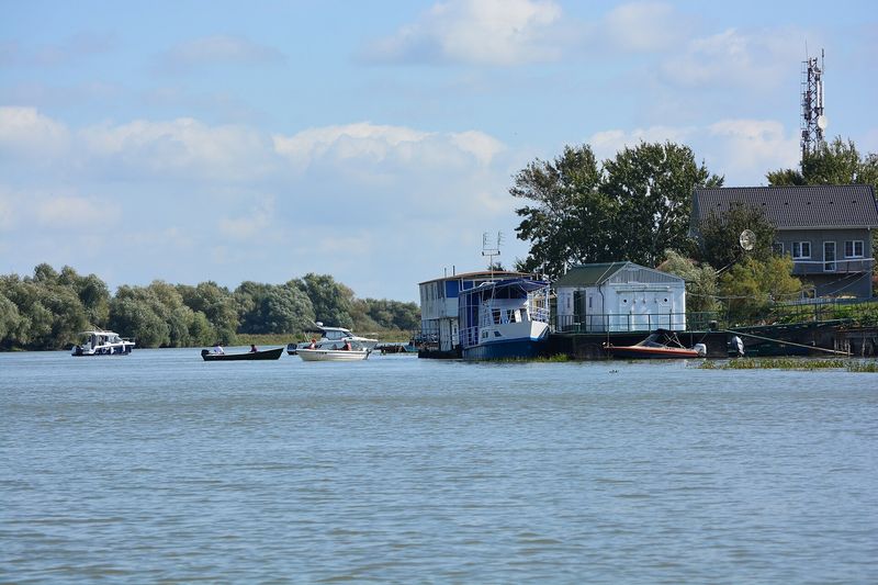 Boats moored along a canal in Mila 23, a Danube Delta fishing village