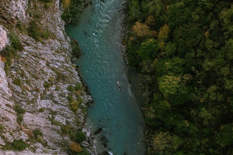 Aerial view of a river beside steep limestone cliffs
