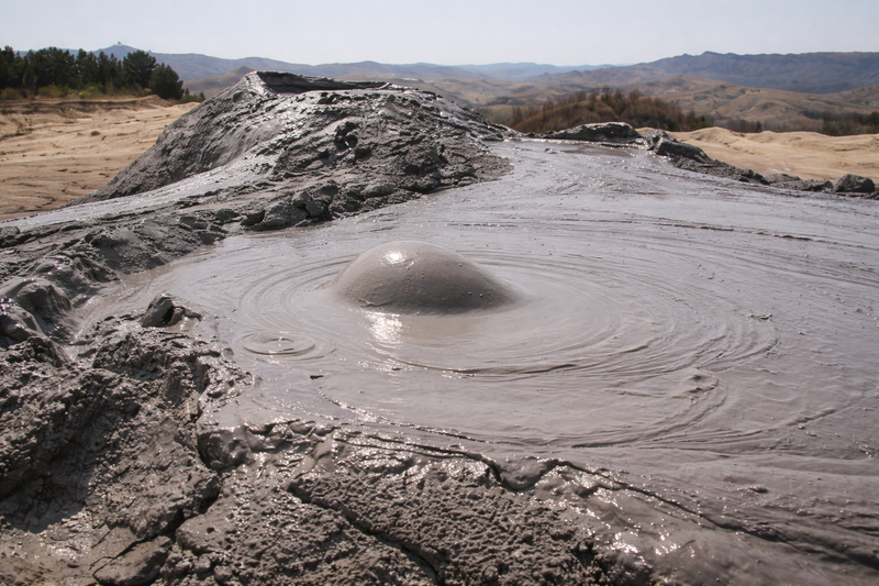 Eroded mud ridges under broad sky