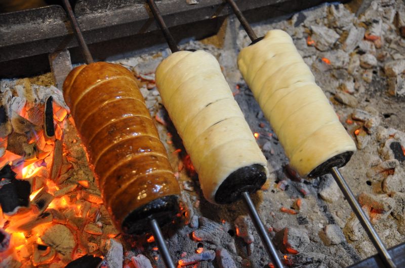 A hot kürtőskalács (chimney cake) fresh off the spit, a Transylvanian Saxon and Hungarian pastry
