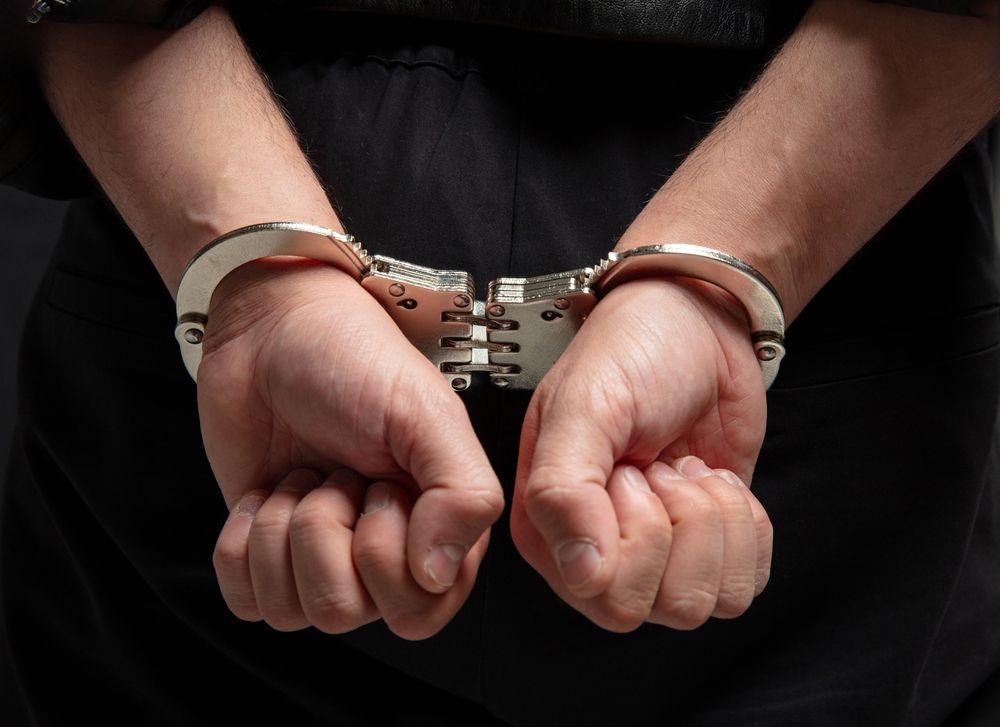 Person in handcuffs behind their back representing criminal charges and Megan’s Law registration consequences in New Jersey