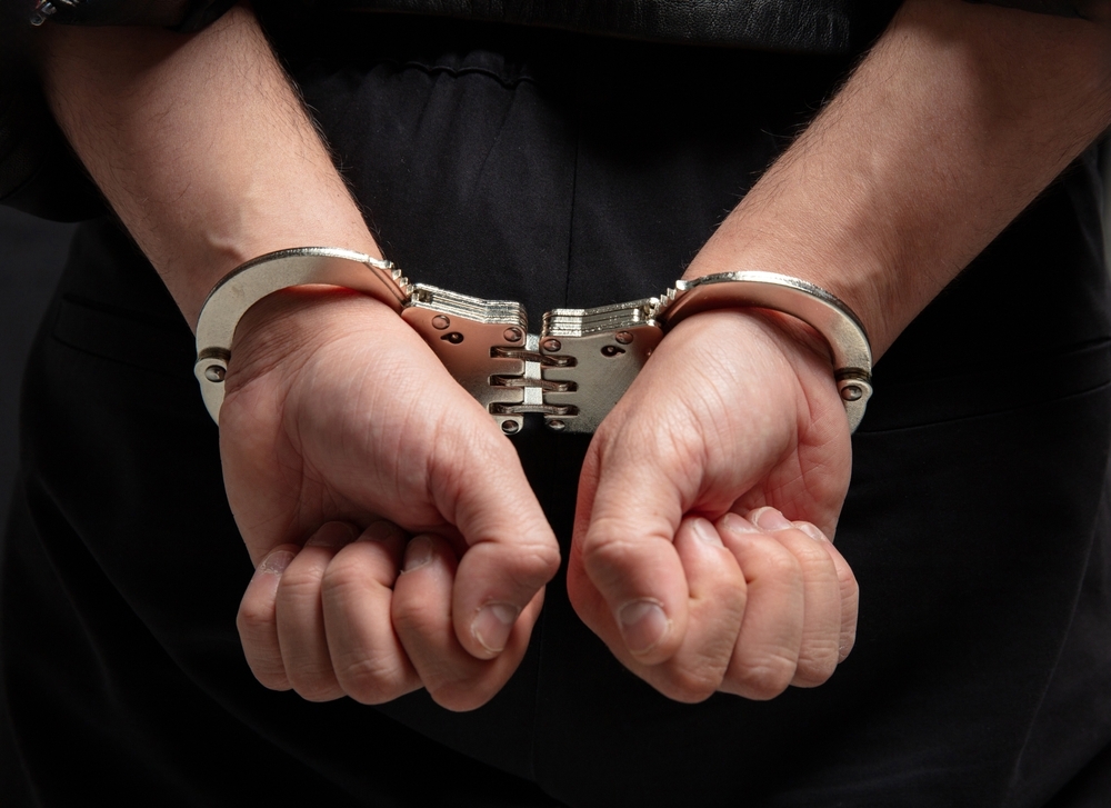 Image Person in handcuffs behind their back representing criminal charges and Megan’s Law registration consequences in New Jersey