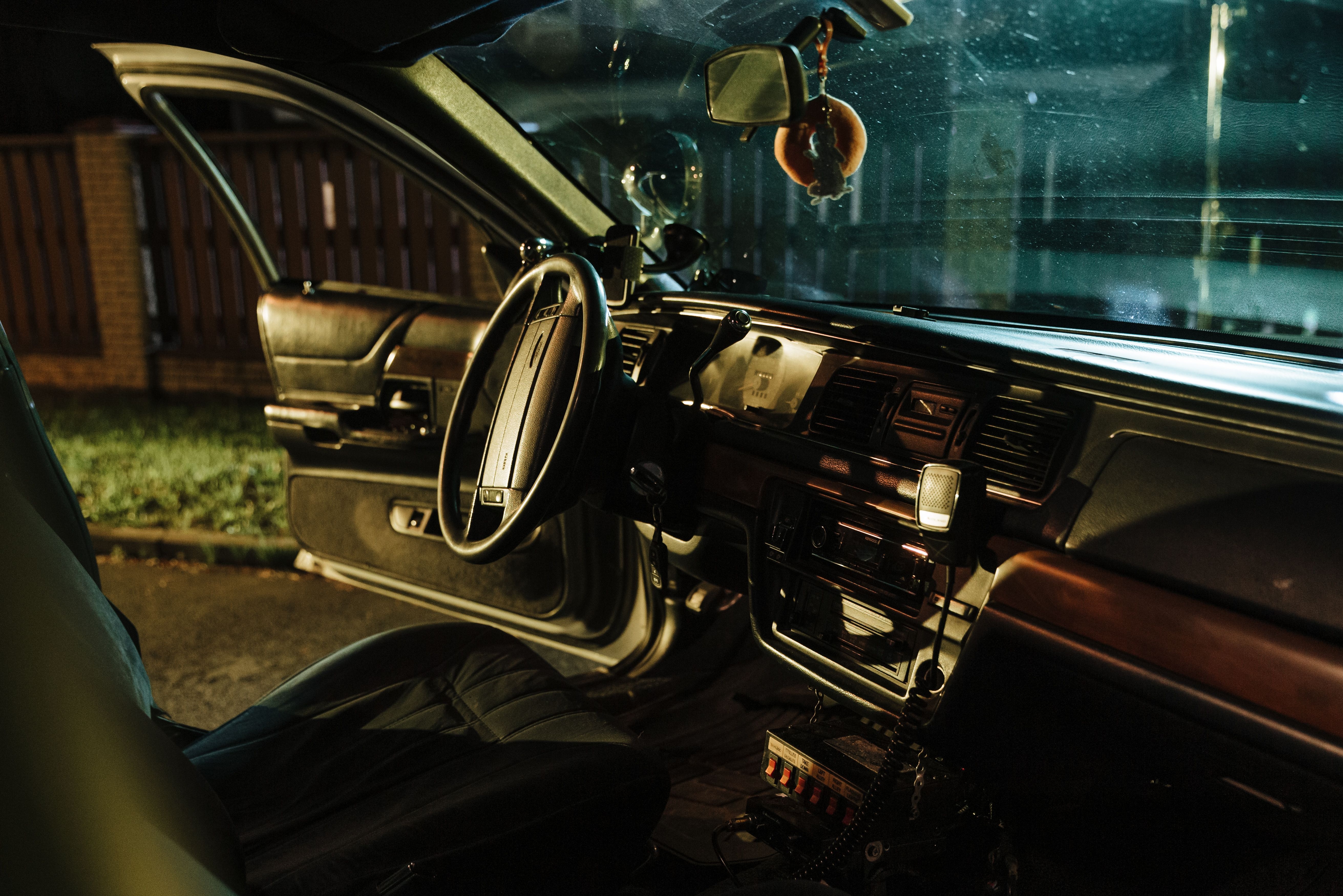 Image Night view of a vintage car interior with the driver's door open, steering wheel visible, symbolizing a vehicle theft or carjacking scenario in New Jersey