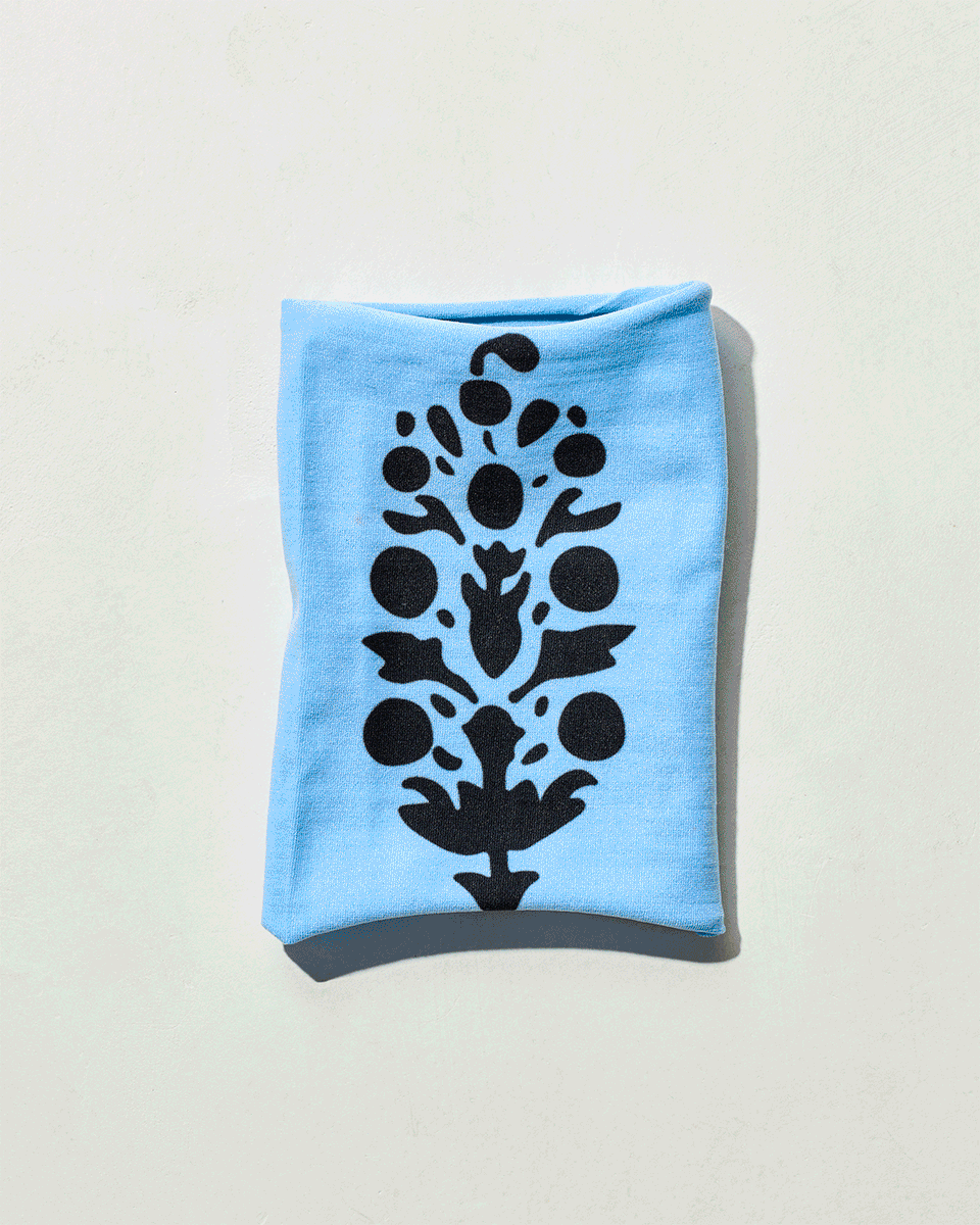 A blue patterned fabric accessory shifting across a pale background in an animated study