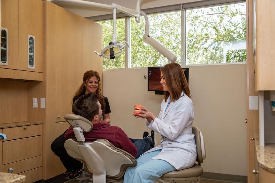 Dentist explains essential dental services to patient in Campbell CA