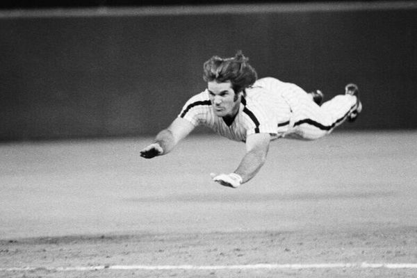 Pete Rose performing his signature headfirst dive at a game against the New York Mets in Philadelphia