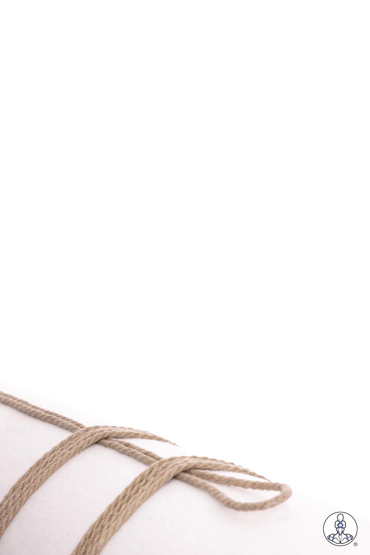 Natural jute rope laid flat showing the beginning formation of a basic overhand knot or crossing pattern against a white background, demonstrating foundational rope handling technique.