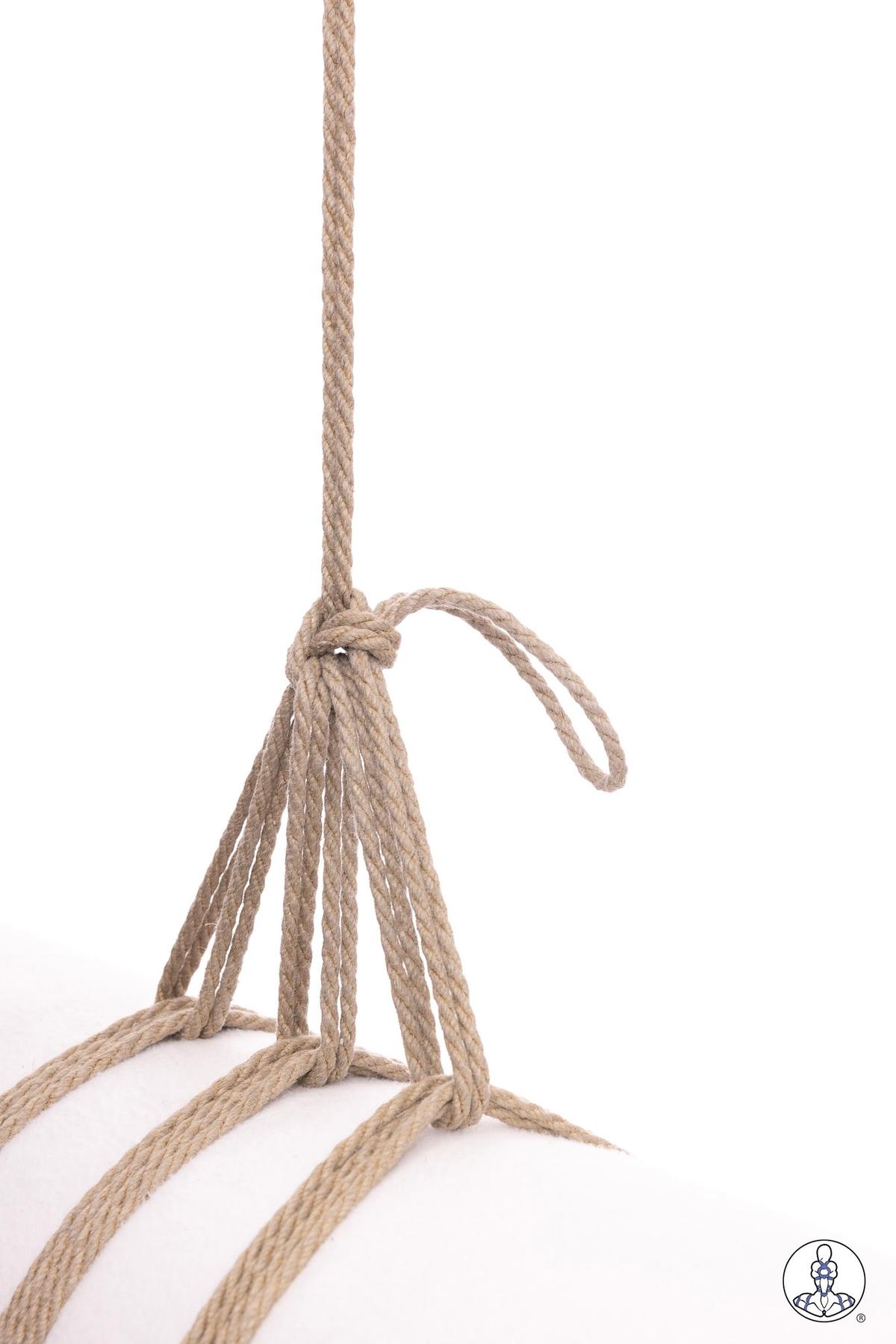 Natural jute rope gathered and knotted at the top with multiple strands hanging downward, showing preparation for a tassel or multi-strand tie configuration with a small loop extending from the gathering knot.
