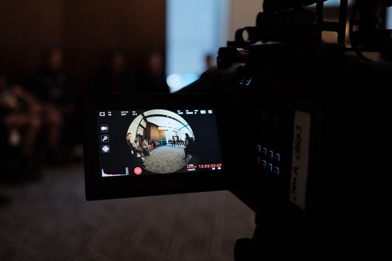 Camera monitor showing immersive circular view during team meeting