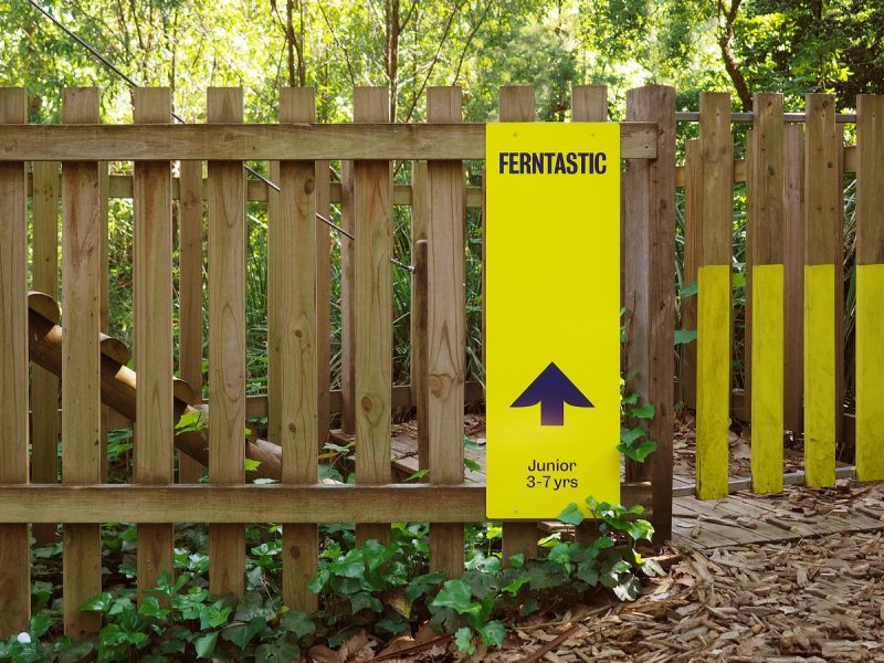 Wayfinding Sign on Wooden Fence