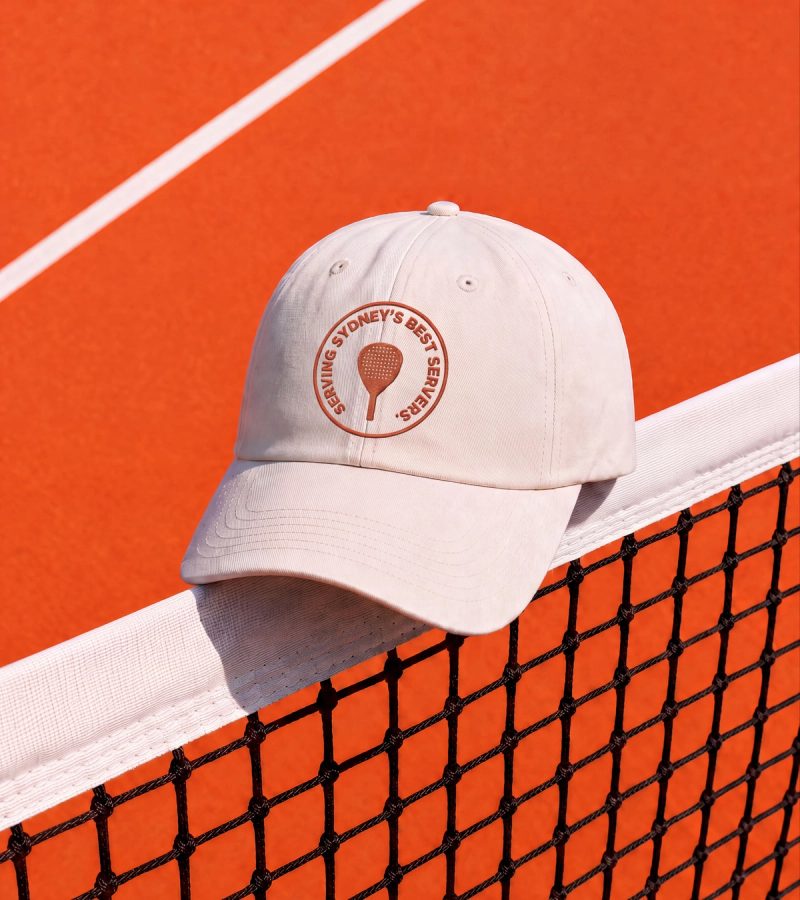 Paddle badge cap on court net