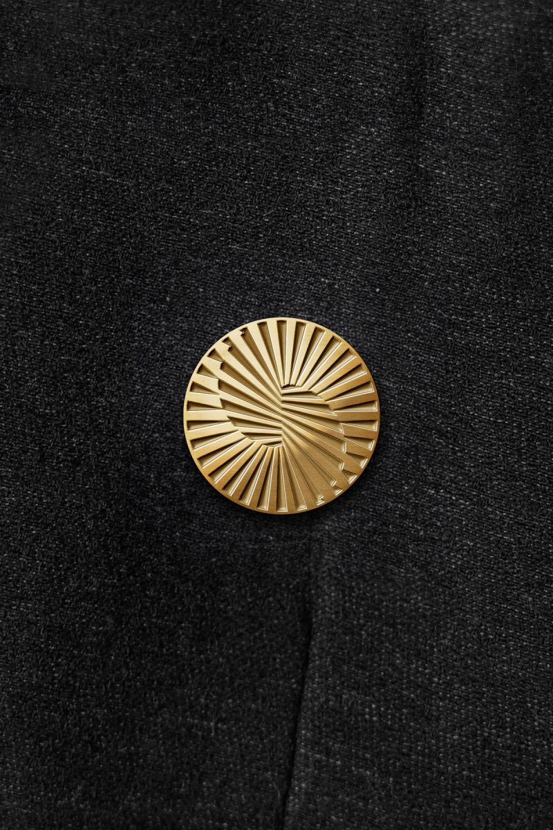 Gold Radiating Coin Emblem