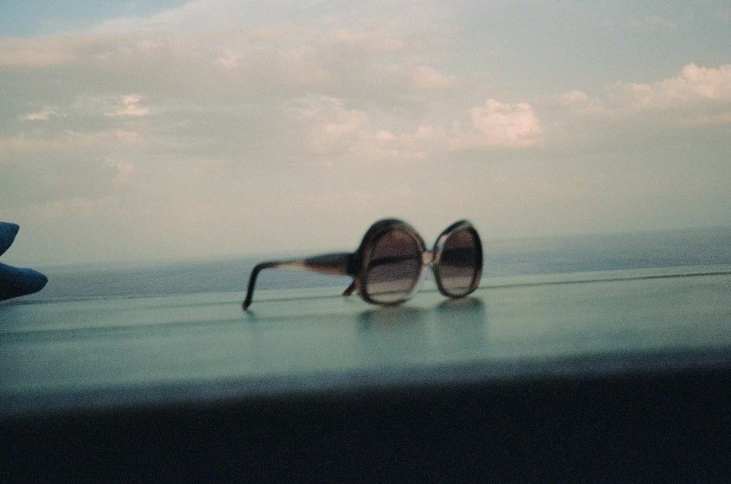 Sunglasses resting on a rock by the sea