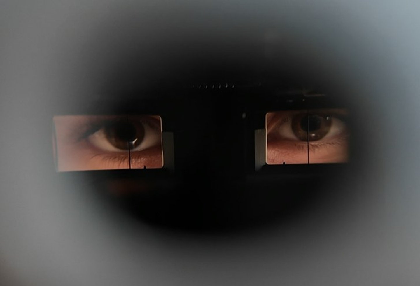 A pair of eyes seen through a vintage lens