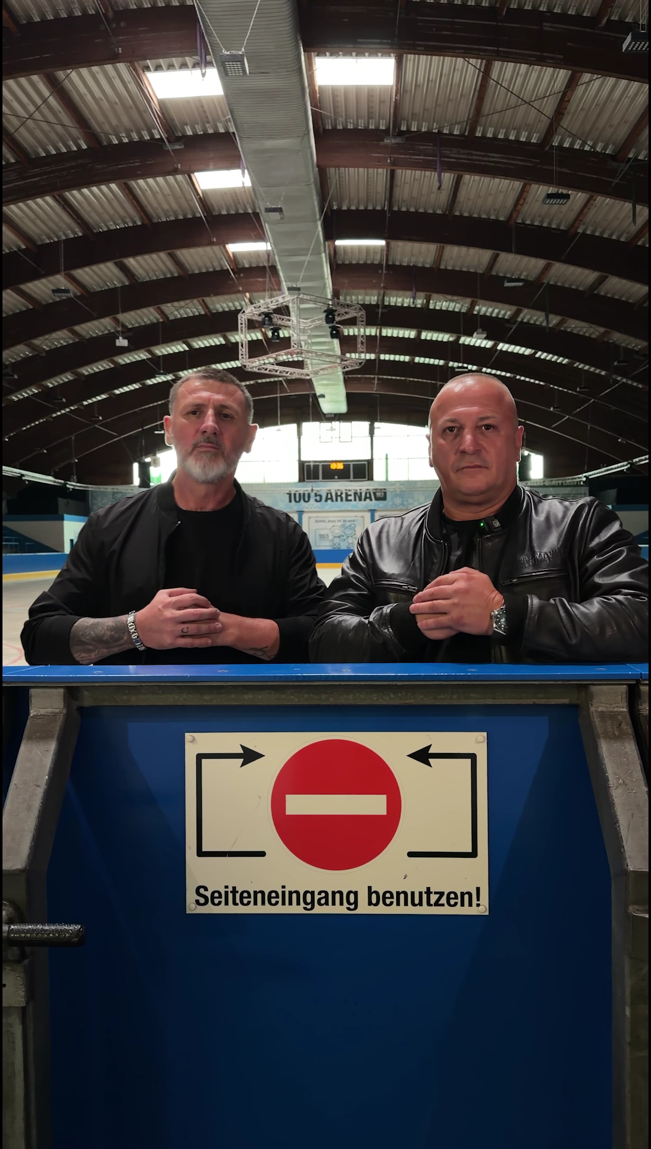 Two people behind a blue barrier marked with a no-entry sign in an industrial interior, from the Subway campaign.