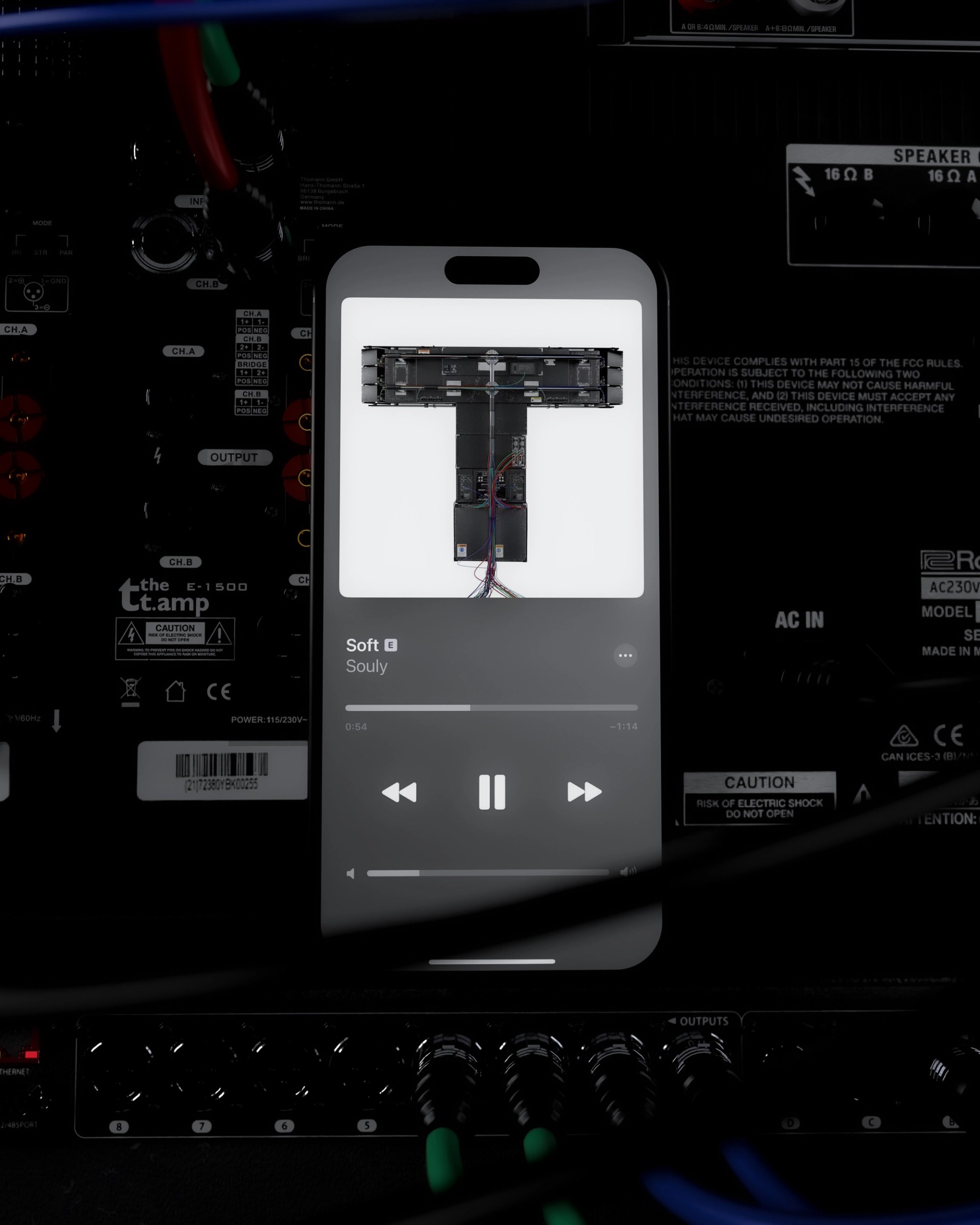 Phone playing Souly's "Soft" with the TRAENCE cover on screen, lying on the rear panel of an amplifier.