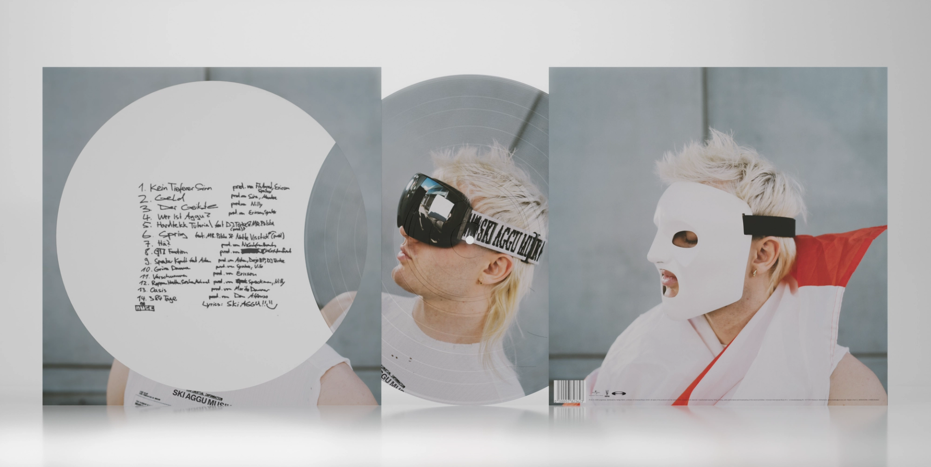 SkiAgguMusik picture-disc packaging with portraits of a goggled performer and a white theatrical mask, alongside a printed track list.