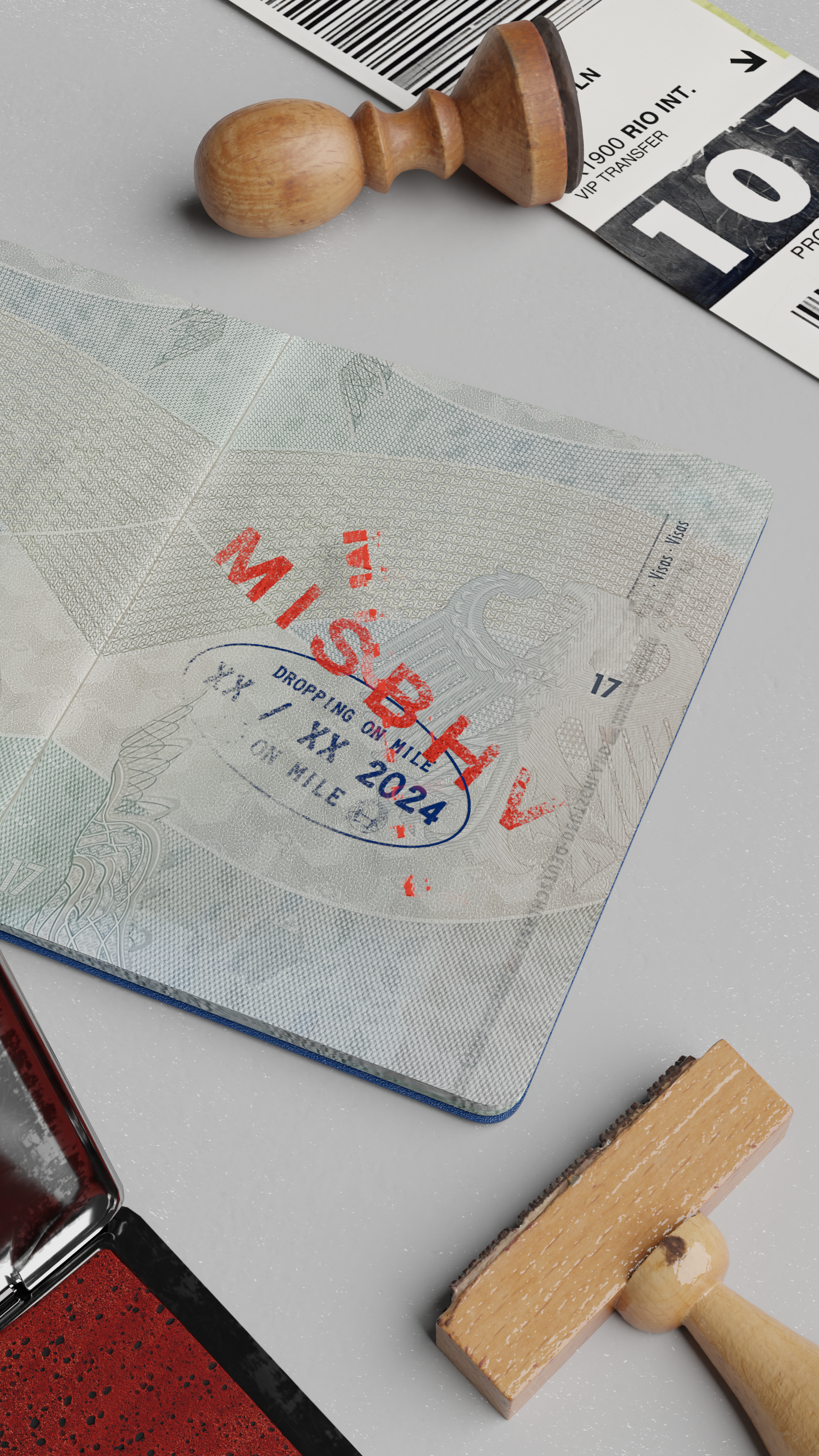 Open passport on a grey desk with a red "MISBHV" stamp over a blue oval date stamp, surrounded by wooden rubber stamps, a red ink pad and a baggage tag.