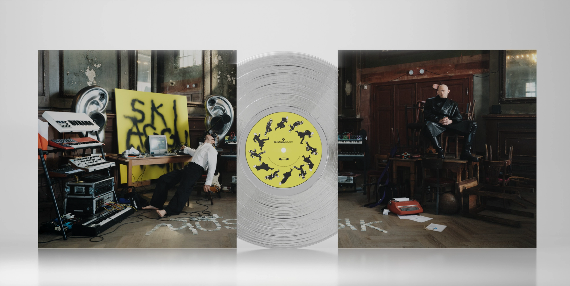 Open SkiAgguMusik gatefold sleeve showing the album-cover set, with a transparent record and yellow label between its panels.