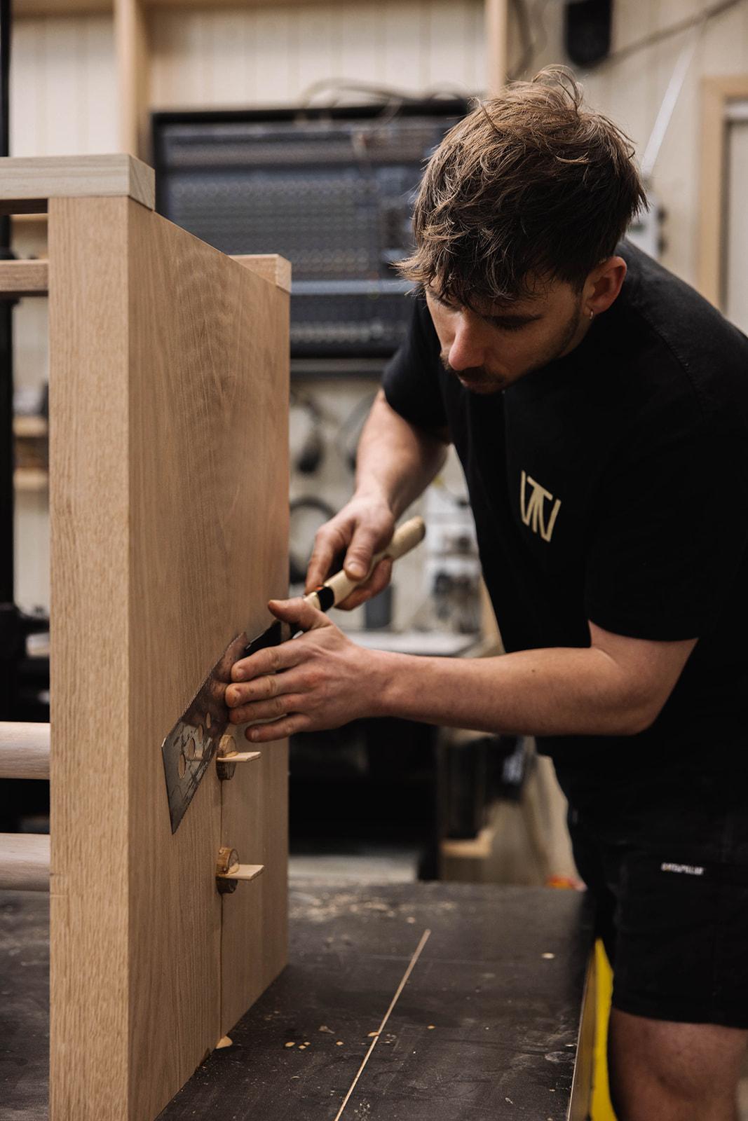 Cory hand sawing wedged-tenon joints flush, for a Murphie Dining Table.