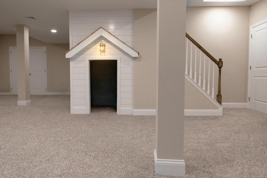 A photo of a modern finished basement with custom playhouse