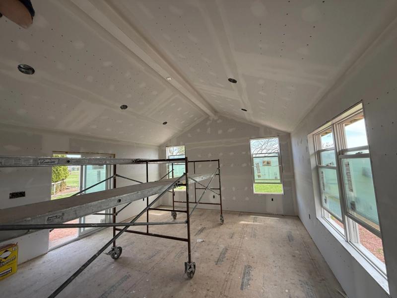Photo of renovation nearing completion with unpainted drywall