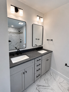 Light gray double vanity with dark countertop