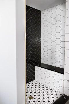primary bath shower white hexagon tile and black herringbone tile