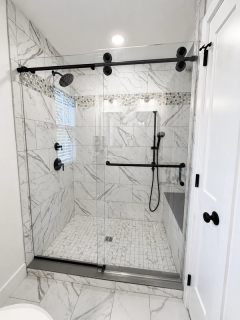 Walk-in shower with large white and gray horizonal tiles