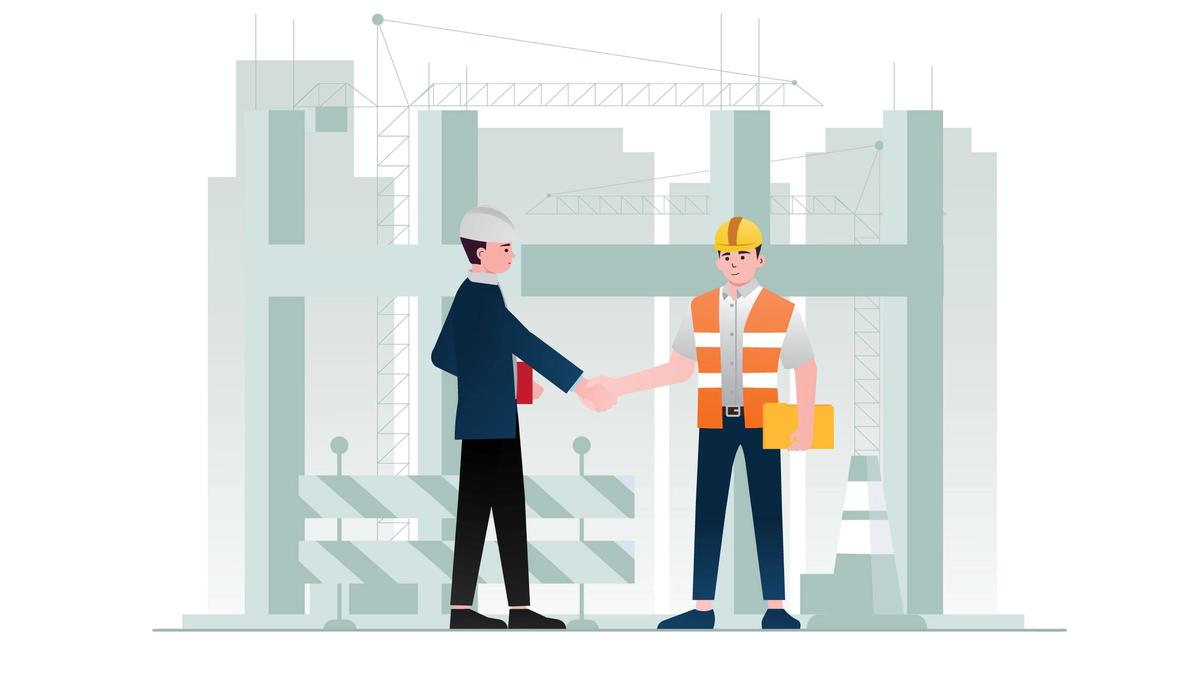 Contractor and buyer shaking hands on a construction site after a tender award