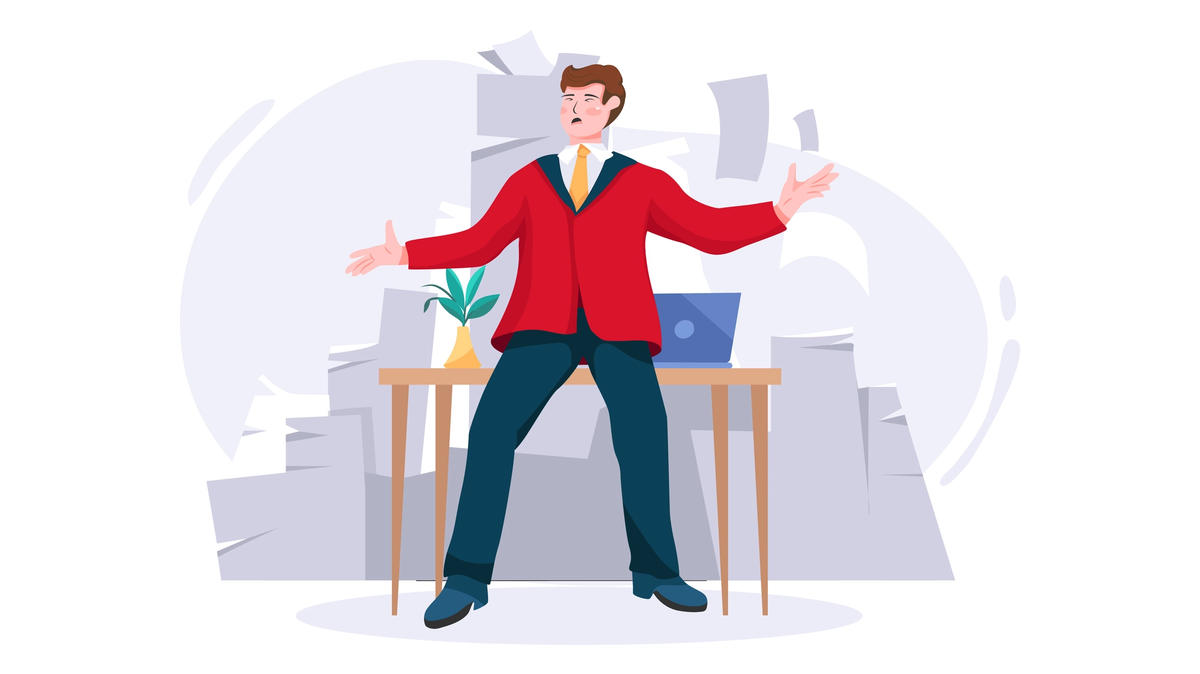 Office worker surrounded by tall stacks of paperwork