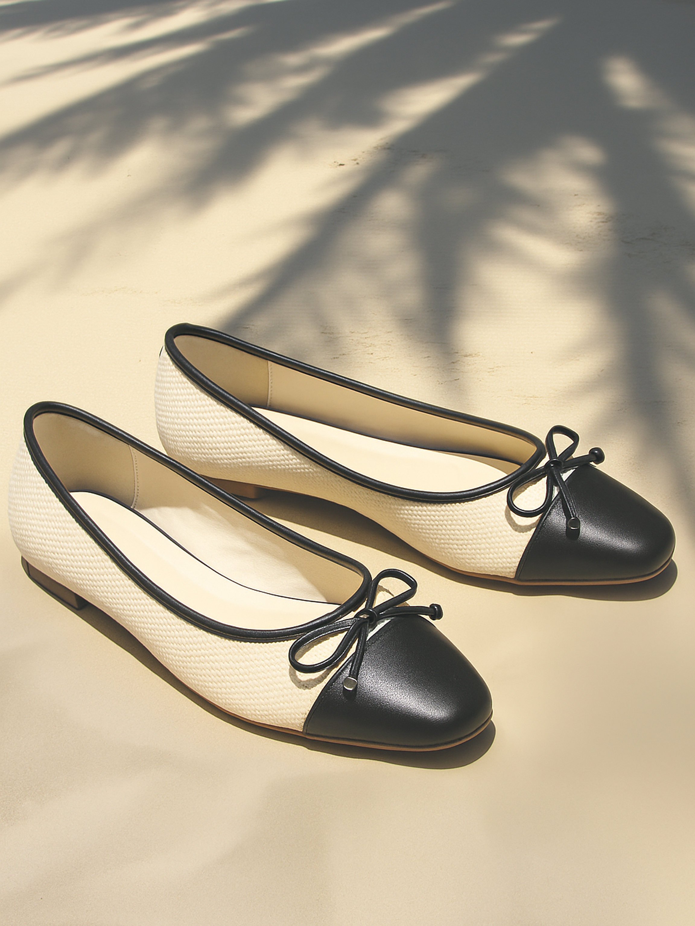 Product photography of black ballet flats