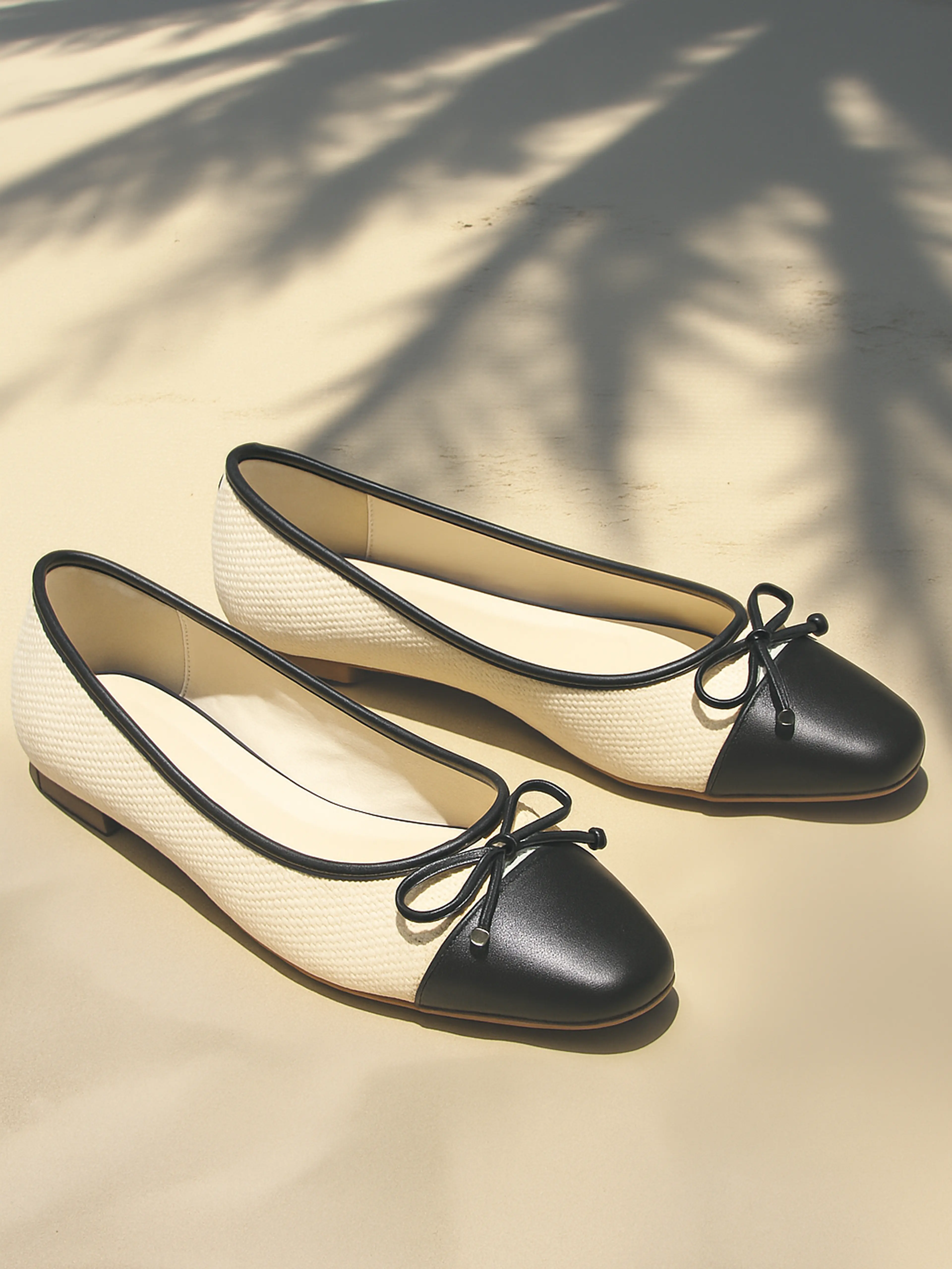 Product photography of black ballet flats