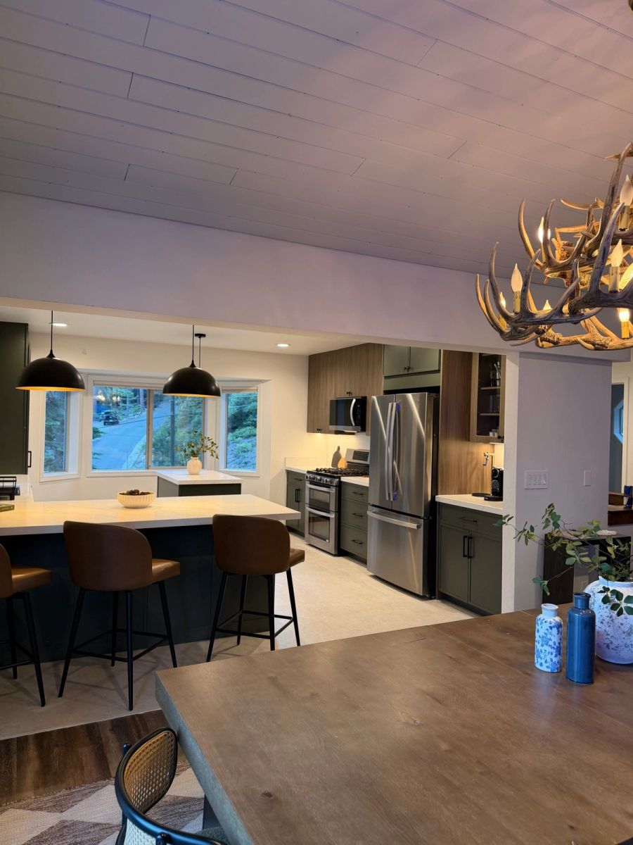 Kitchen and dining beneath the antler chandelier