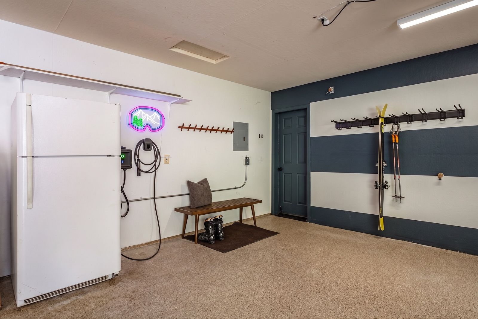 The garage at Starfall Lodge with EV charger and gear racks
