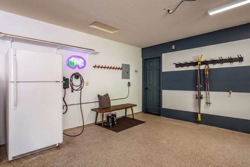 The garage at Starfall Lodge with EV charger and gear racks