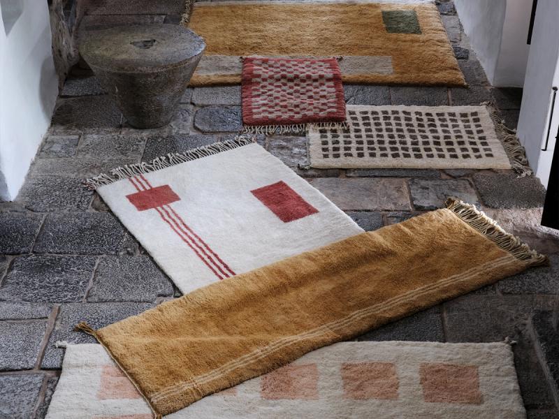 Through Line rug layered with other rugs. 