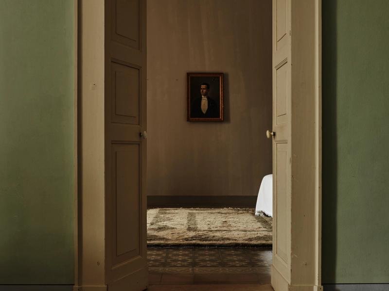 Taglio rug seen through doorway. 